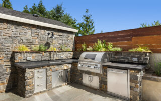 Backyard hardscape patio with outdoor barbecue and kitchen